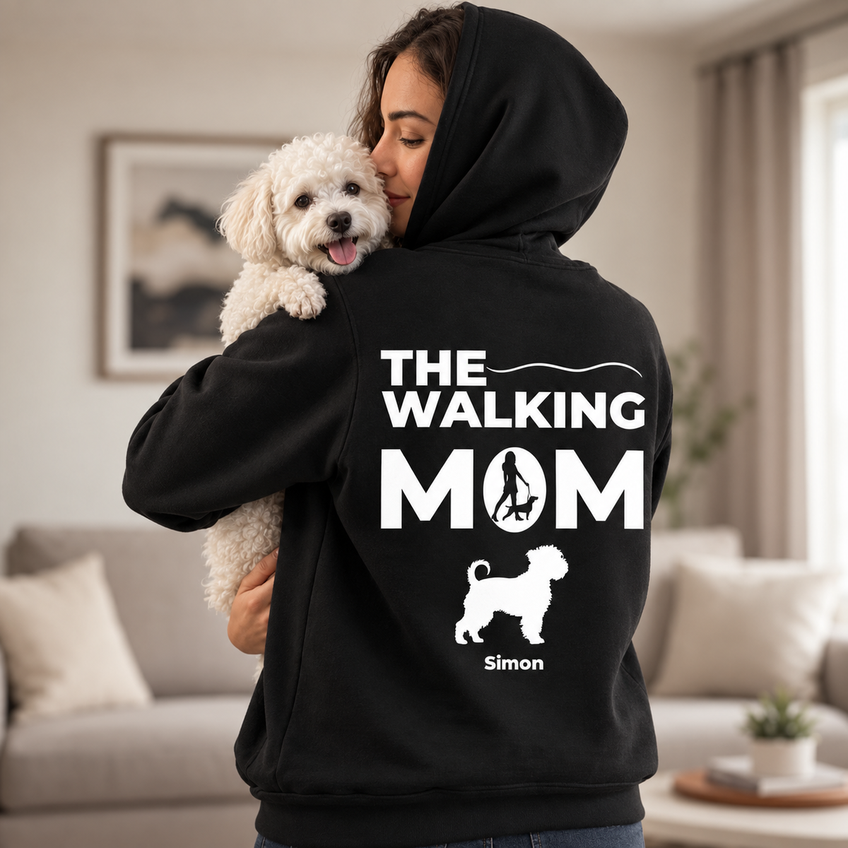 Black hoodie with the text "THE WALKING MOM", a graphic of a woman with a dog and the name "Simon".
