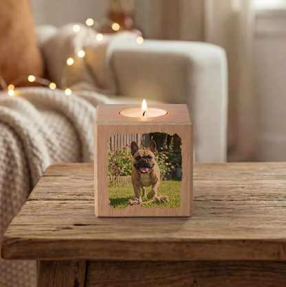 Personalized wooden candle cube with photo and burning candle on top.