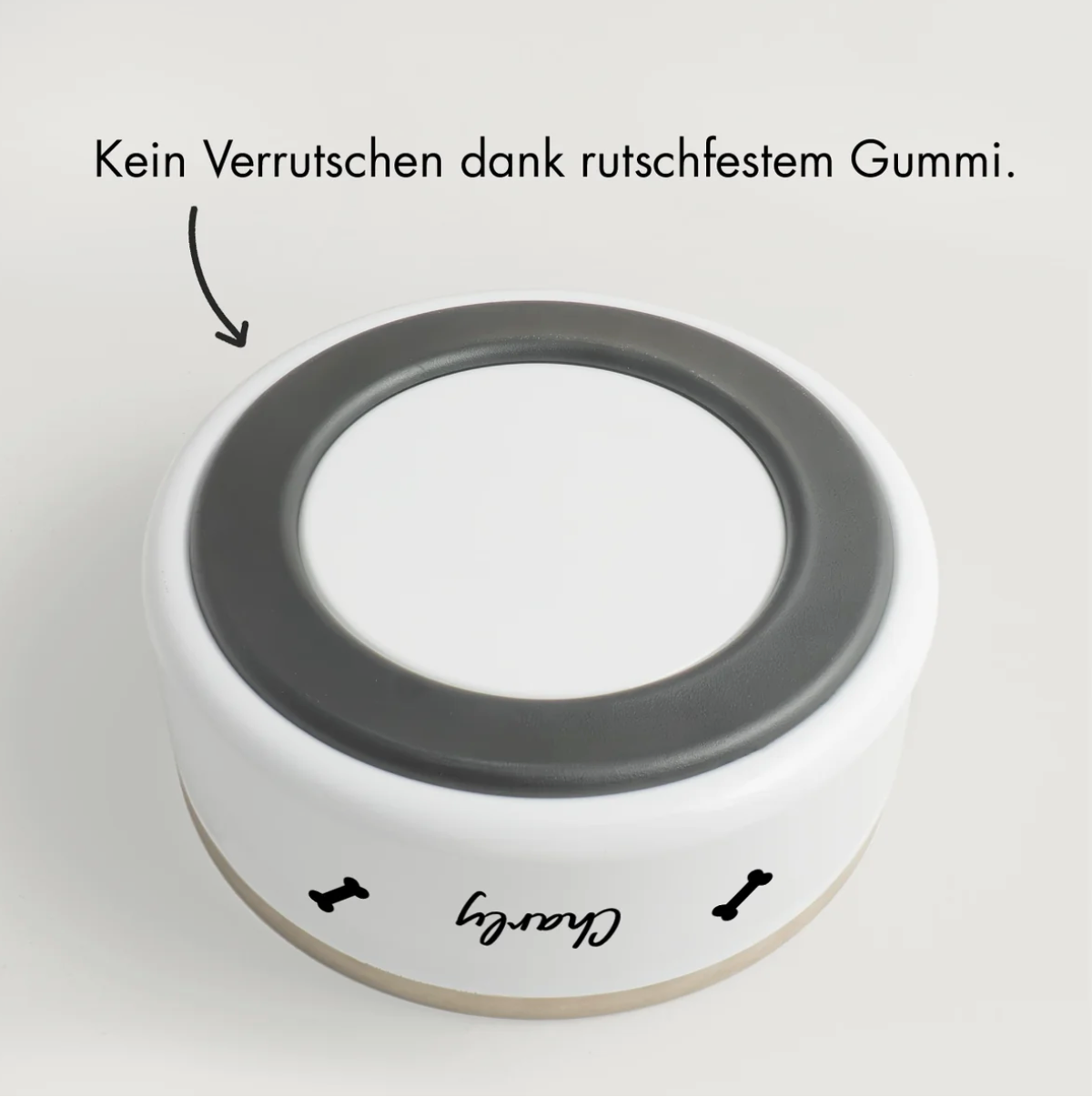 Personalized pet bowl with non-slip rubber base, white with a black inner rim.